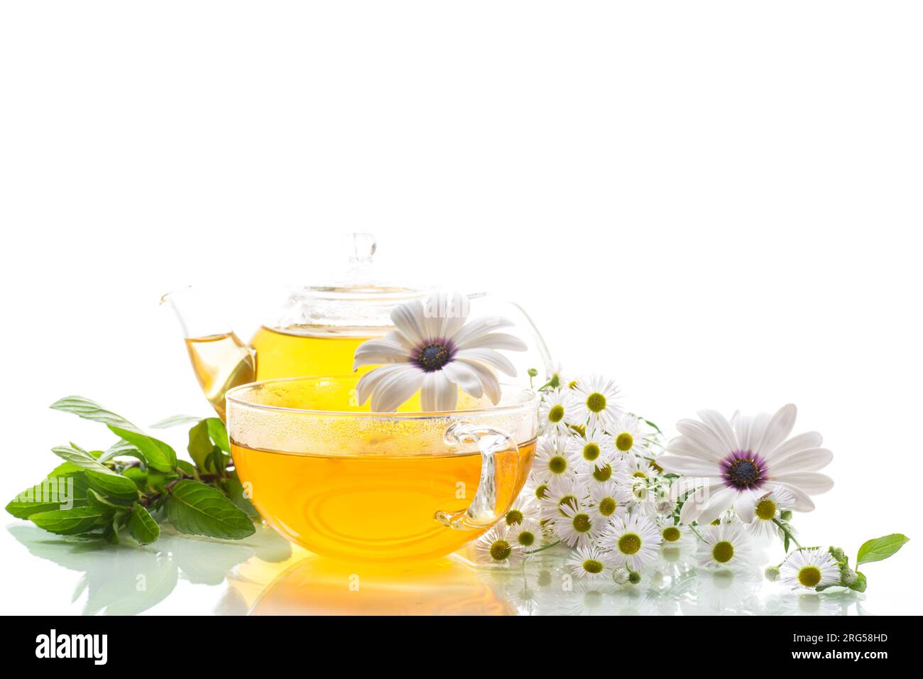 Chamomile flower tea in glass cup and teapot, isolated on white ...