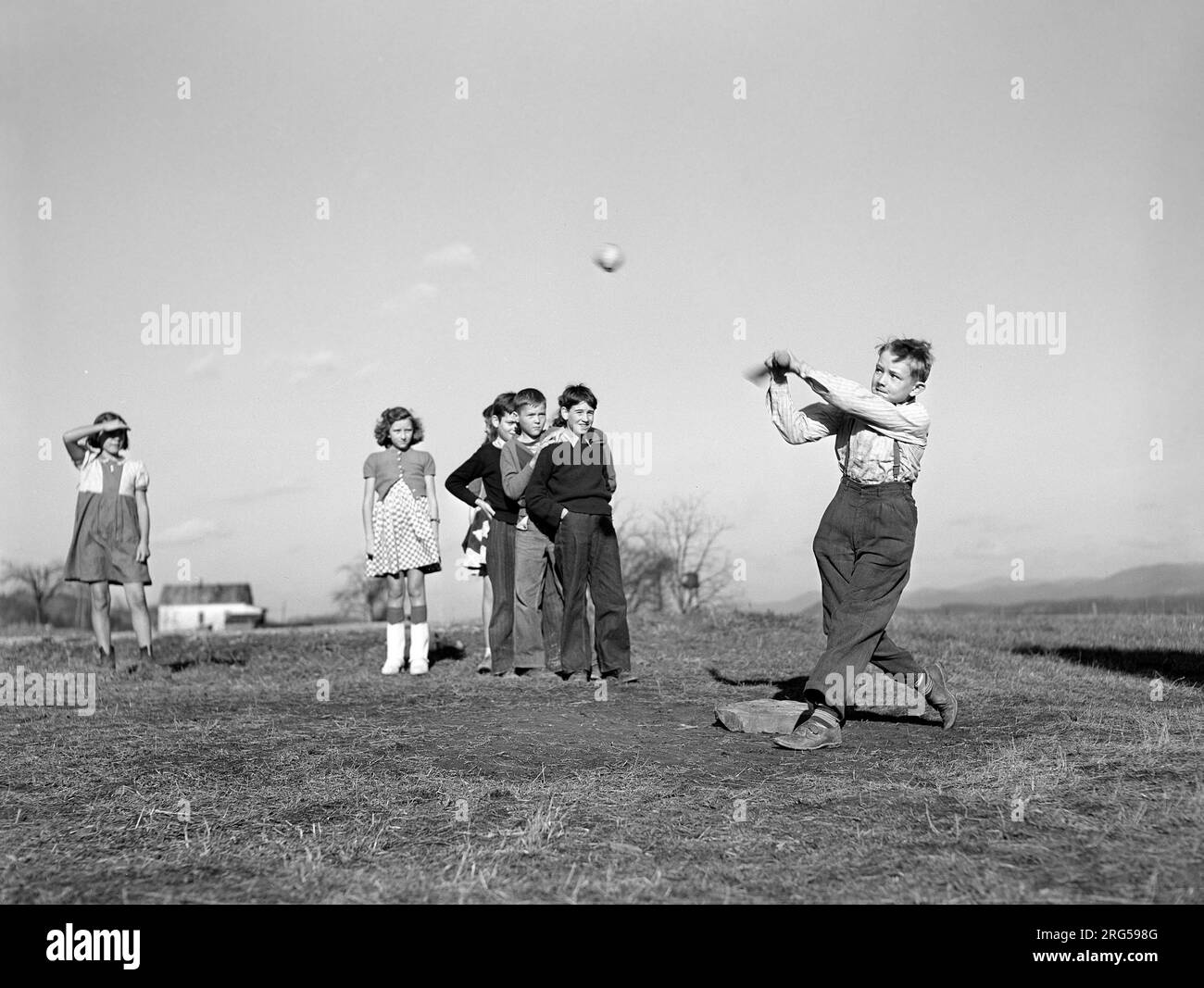 Children playing baseball game during afternoon play period, homestead school, Dailey, West Virginia, USA, Arthur Rothstein, U.S. Farm Security Administration, October 1941 Stock Photo