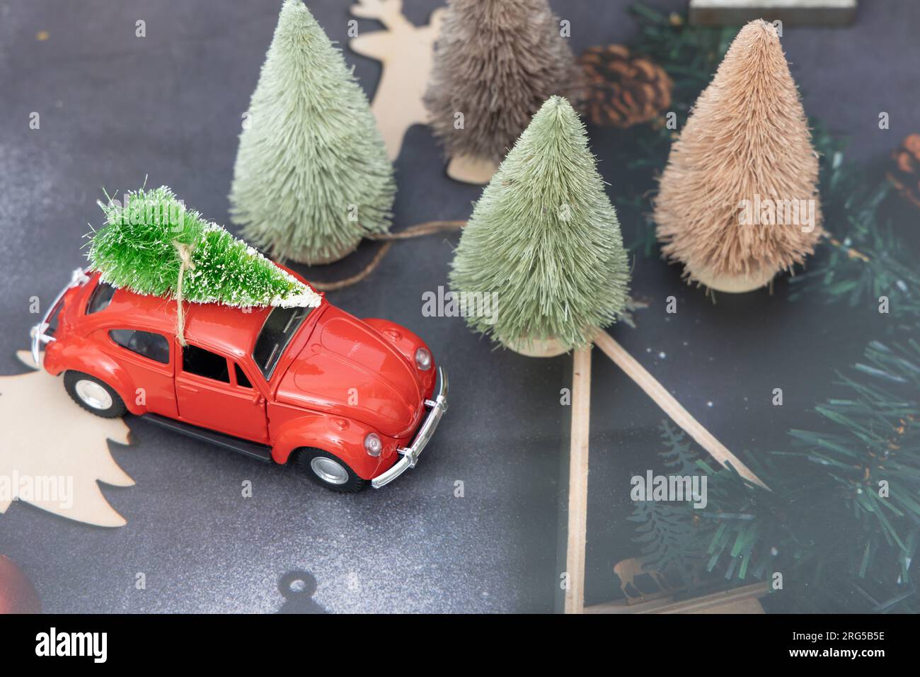 Vintage red car decor with Christmas Tree. Transporting Christmas tree car.  Christmas party decoration Stock Photo - Alamy