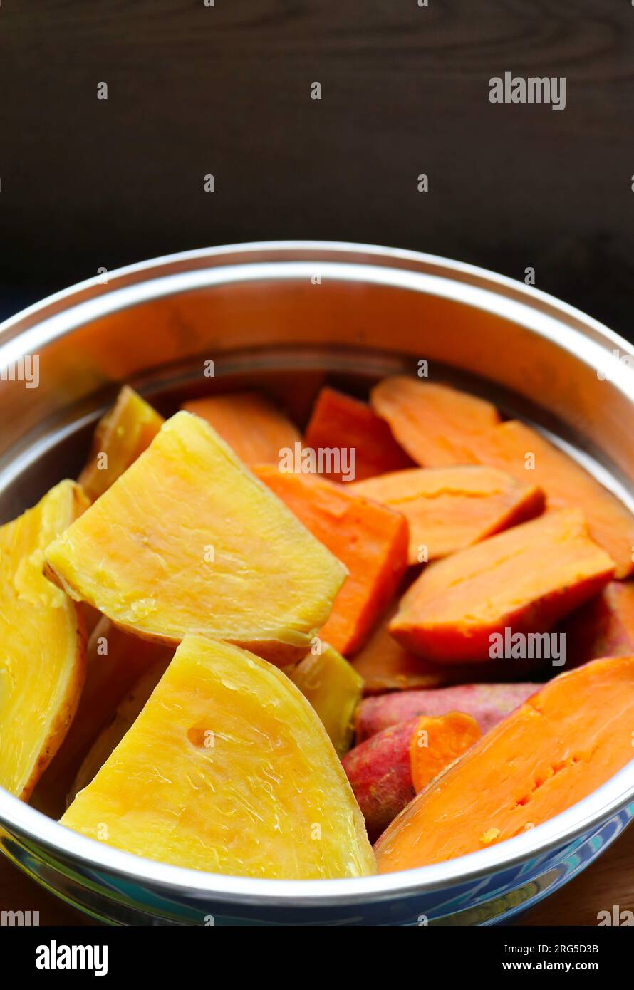 Pile of Freshly Steamed Sweet Potatoes in a Steaming Pot Stock Photo