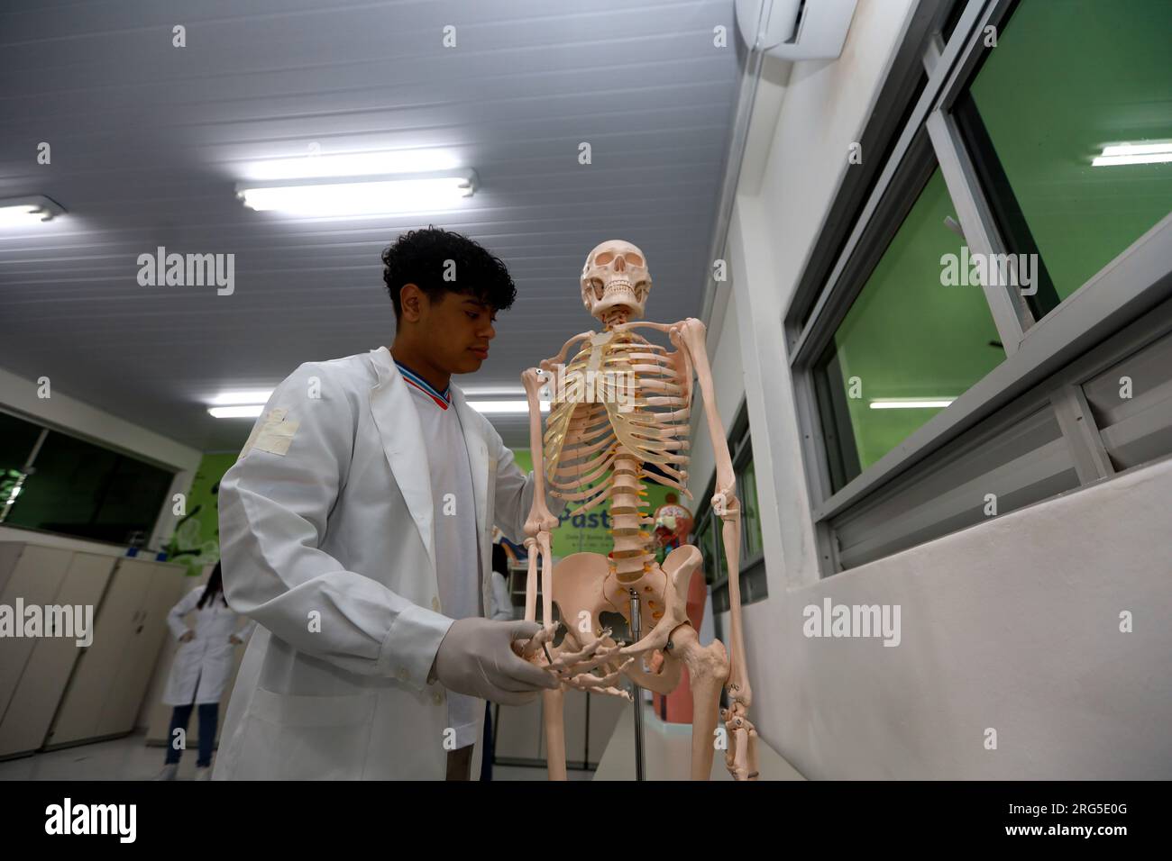 itaju do colonia, bahia, brazil - july 23, 2023: student next to a human skeleton in a public school classroom in Bahia. Stock Photo