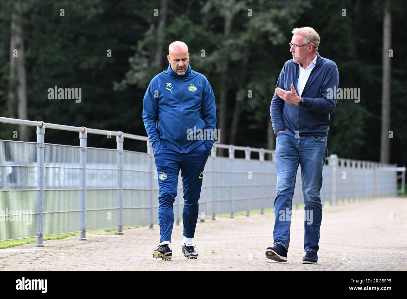 EINDHOVEN - Coach Peter Bosz, former goalkeeper Hans van Breukelen, who is a member of the PSV RVC until September 1. PSV trains at the Herdgang prior to the third qualifying round Champions League match against Austria's Sturm Graz. The winner of that preliminary round will compete in the play-offs for a ticket to the group stage. ANP OLAF KRAAK Stock Photo