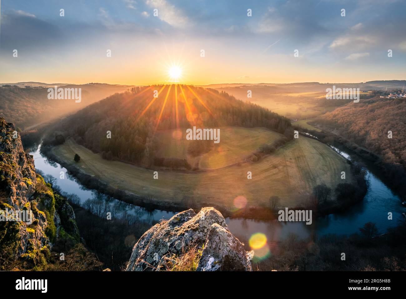 Backlit shot on a mountain with a view of the landscape, sunset, forest ...