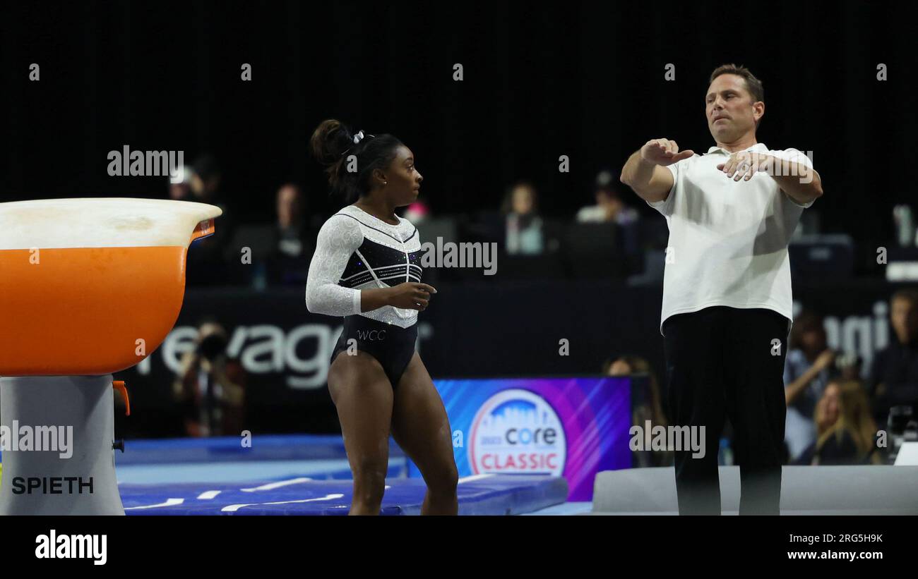 August 5, 2023: Olympic gold medalist SIMONE BILES with coach Laurent Landi during the U.S. Classic. Landi gives Biles tips on the Yurchenko double pike vault she'd just landed in practice. Biles won the all-around and two events in her first competition since the Tokyo 2021 games. The 2023 Core Hydration Classic is being held at the NOW Arena in Hoffman Estates, Illinois. Melissa J. Perenson/CSM (Credit Image: © Melissa J. Perenson/Cal Sport Media) Stock Photo