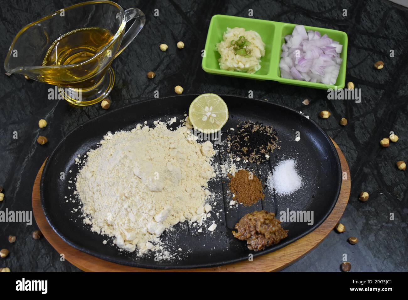 Ingredient of sattu paratha or litti stuffing of Bihar. Include sattu powder, salt, lemon, onion, garlic, pickle, mustard oil, onion seed. Stock Photo