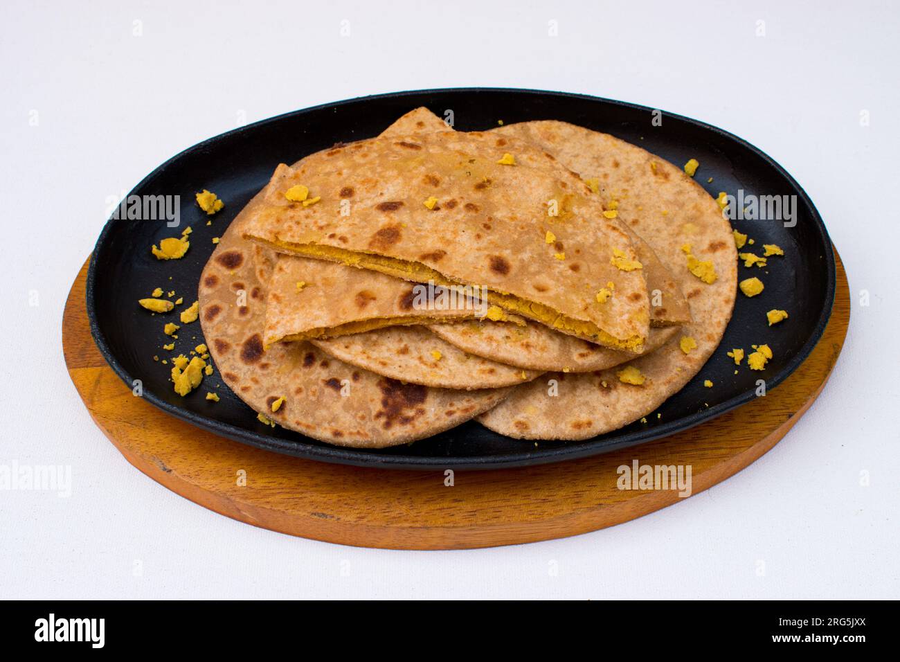 Dal paratha or chana dal stuffed paratha in black plate in white background. Stock Photo
