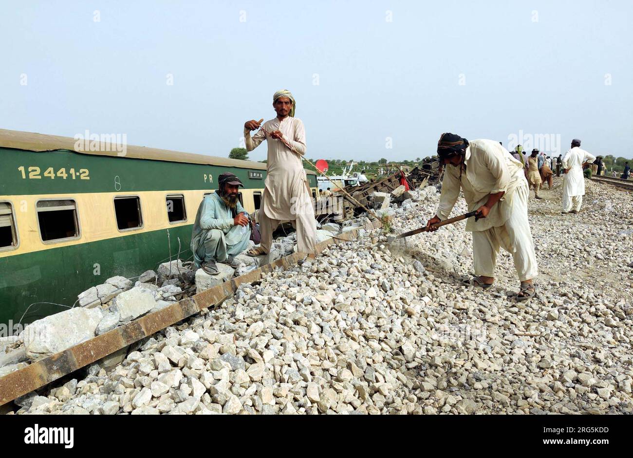 Nawabshah,, August 7, 2023. Heavy machinery and laborers are busy in removing a derailed train and mending works of main stream track of Pakistan Railways after 10 bogies of Havelian-bound Hazara Express derailed on Sunday near Sarhari Railway Station in Nawabshah on Monday, August 7, 2023. Stock Photo
