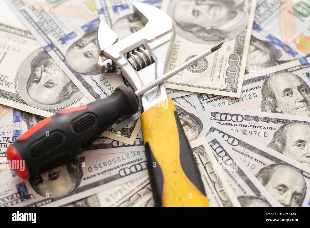 Concept of fixing currency of money and tools. Wrench, Pliers