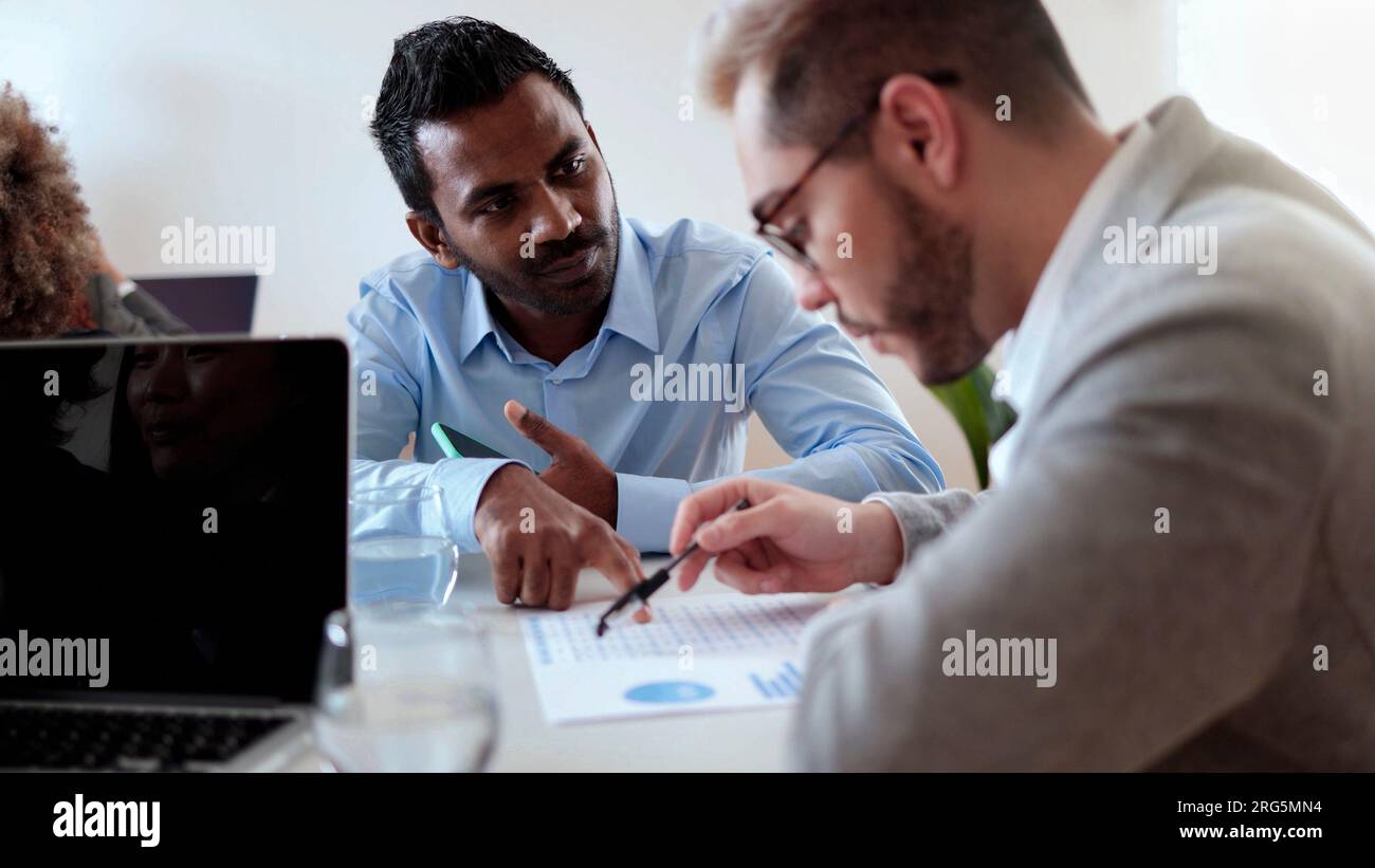 Multiethnic business people working at bank office analyzing data - Entrepreneur financial concept - Focus on Indian man face Stock Photo