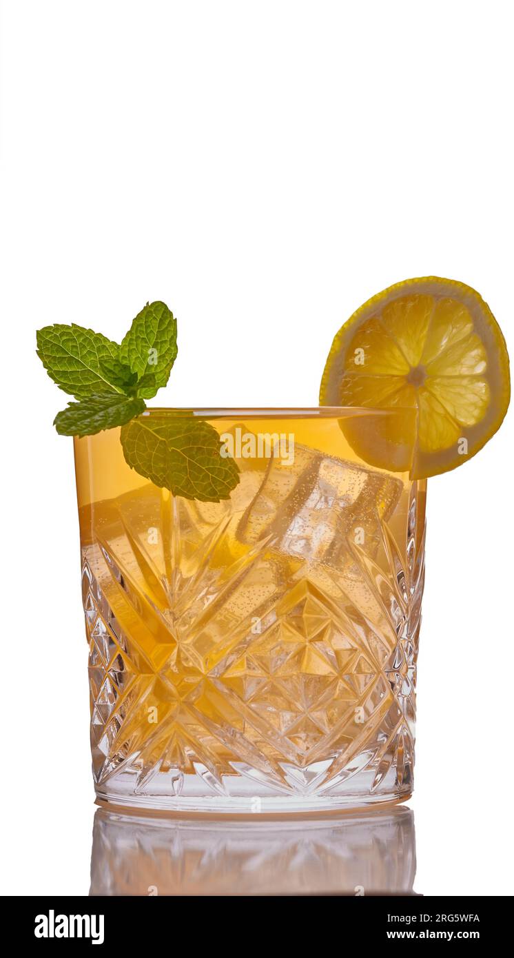 Whisky cocktail garnished with mint and a slice of lemon. Stock Photo