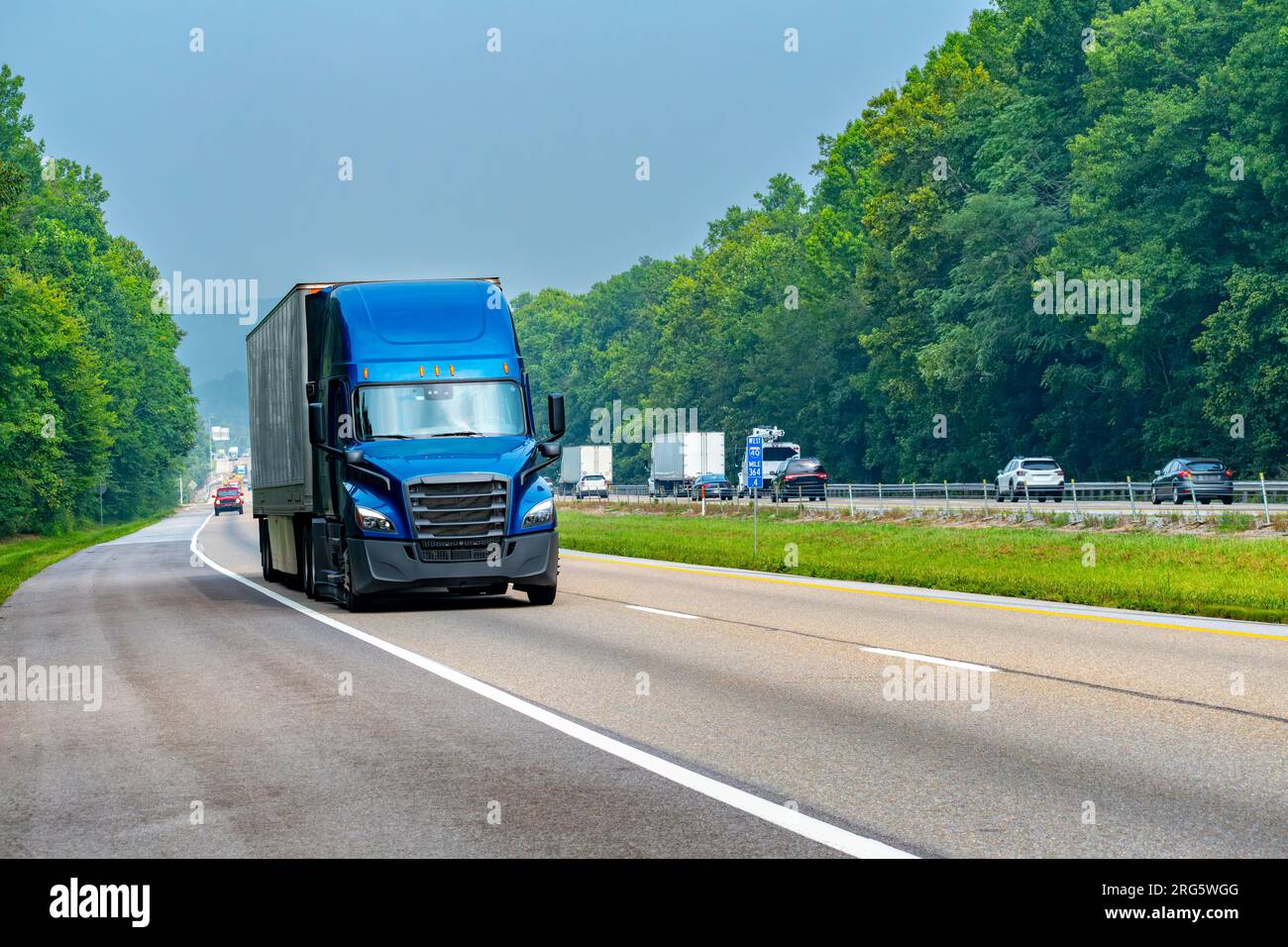 Horizontal shot of Tennessee interstate traffic led by a blue tractor
