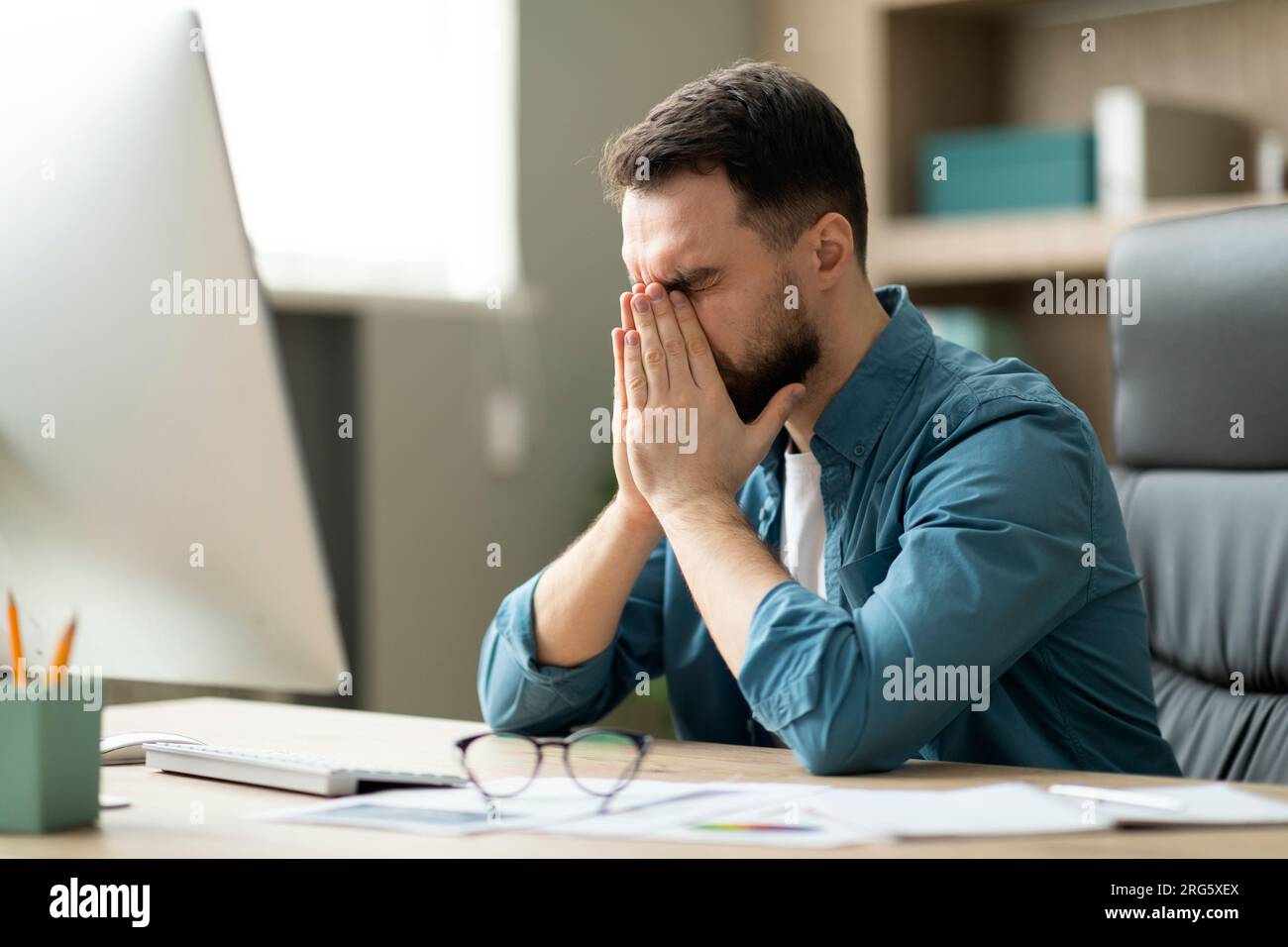 Tired freelancer guy rubbing eyes hi-res stock photography and images ...