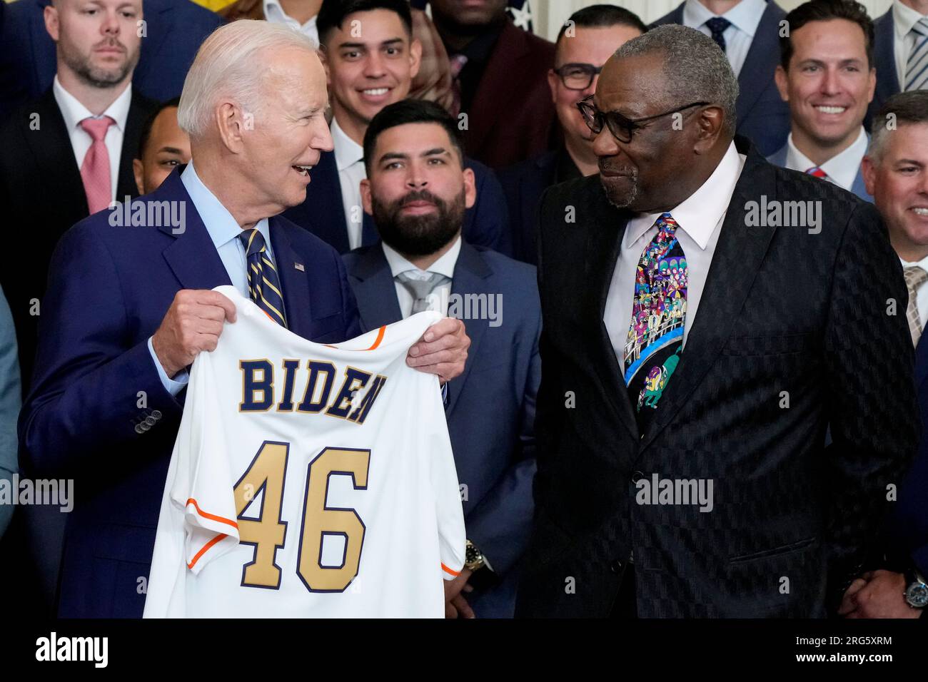 Houston Astros manager Dusty Baker Jr., right, presents a jersey to  President Joe Biden during an event celebrating the 2022 World Series  champion Houston Astros baseball team, in the East Room of