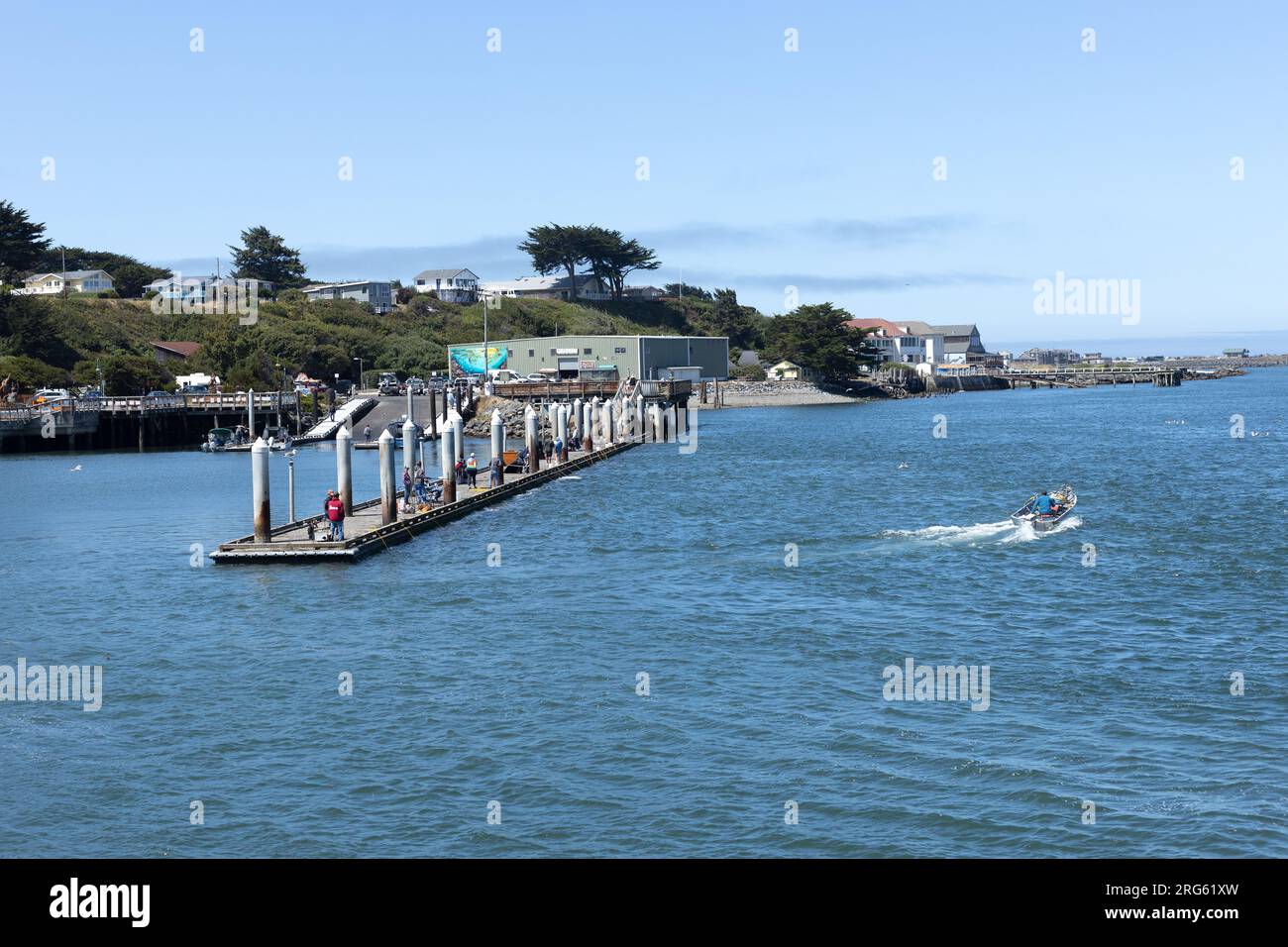 People fishing from Weber's Pier in Bandon, Oregon, on a summer day. Stock Photo