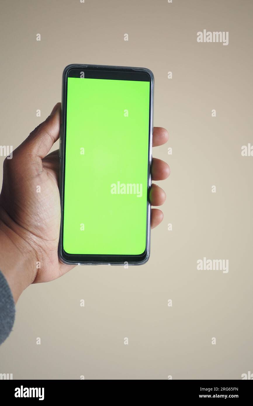 Close up of young man hand using smart phone with green screen Stock ...