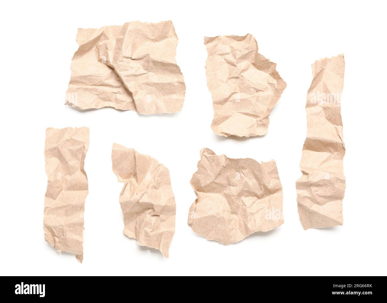 Torn pieces of old creased paper sheets isolated on white background