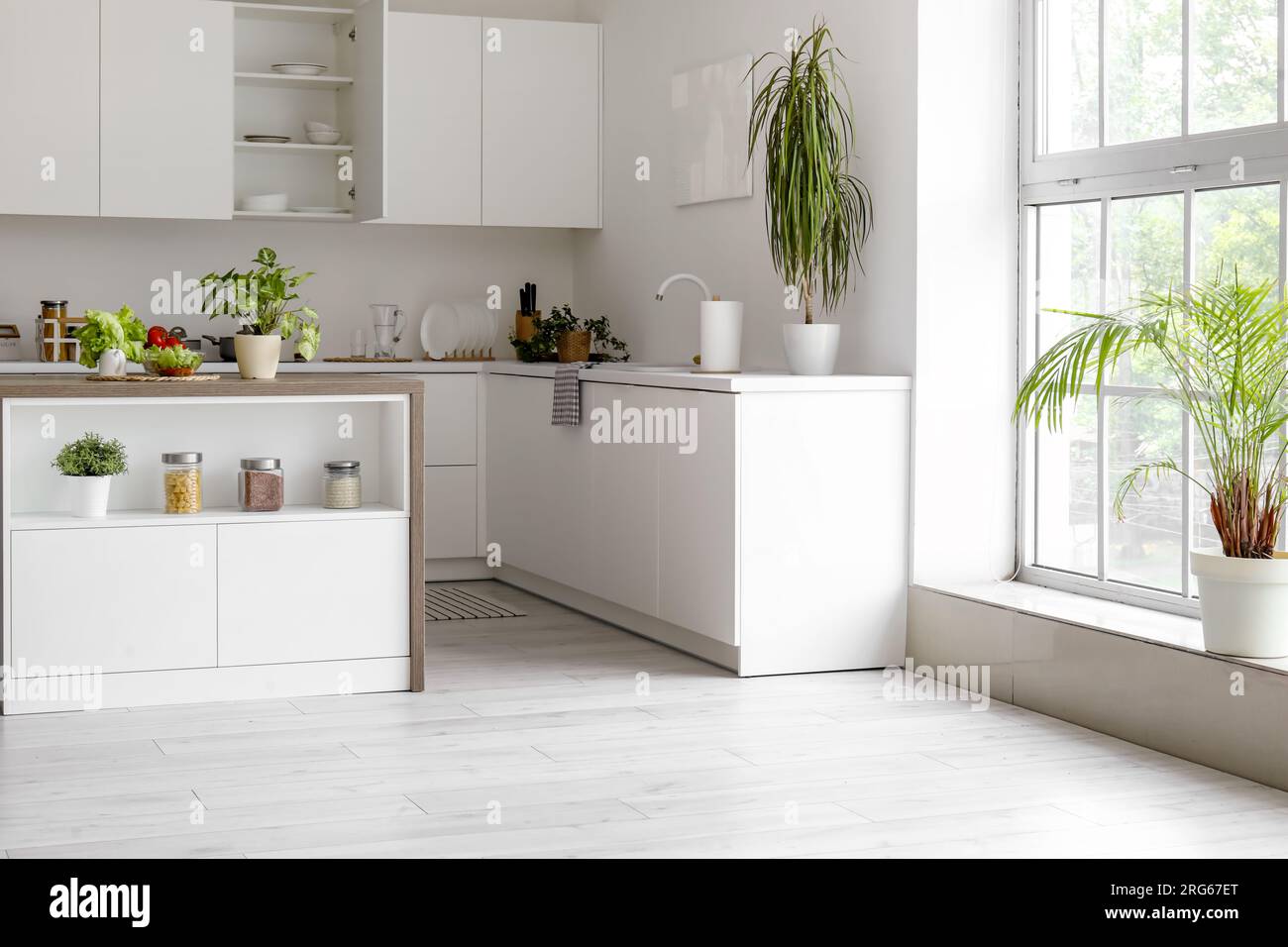 Interior of modern kitchen with white counters and island table Stock ...