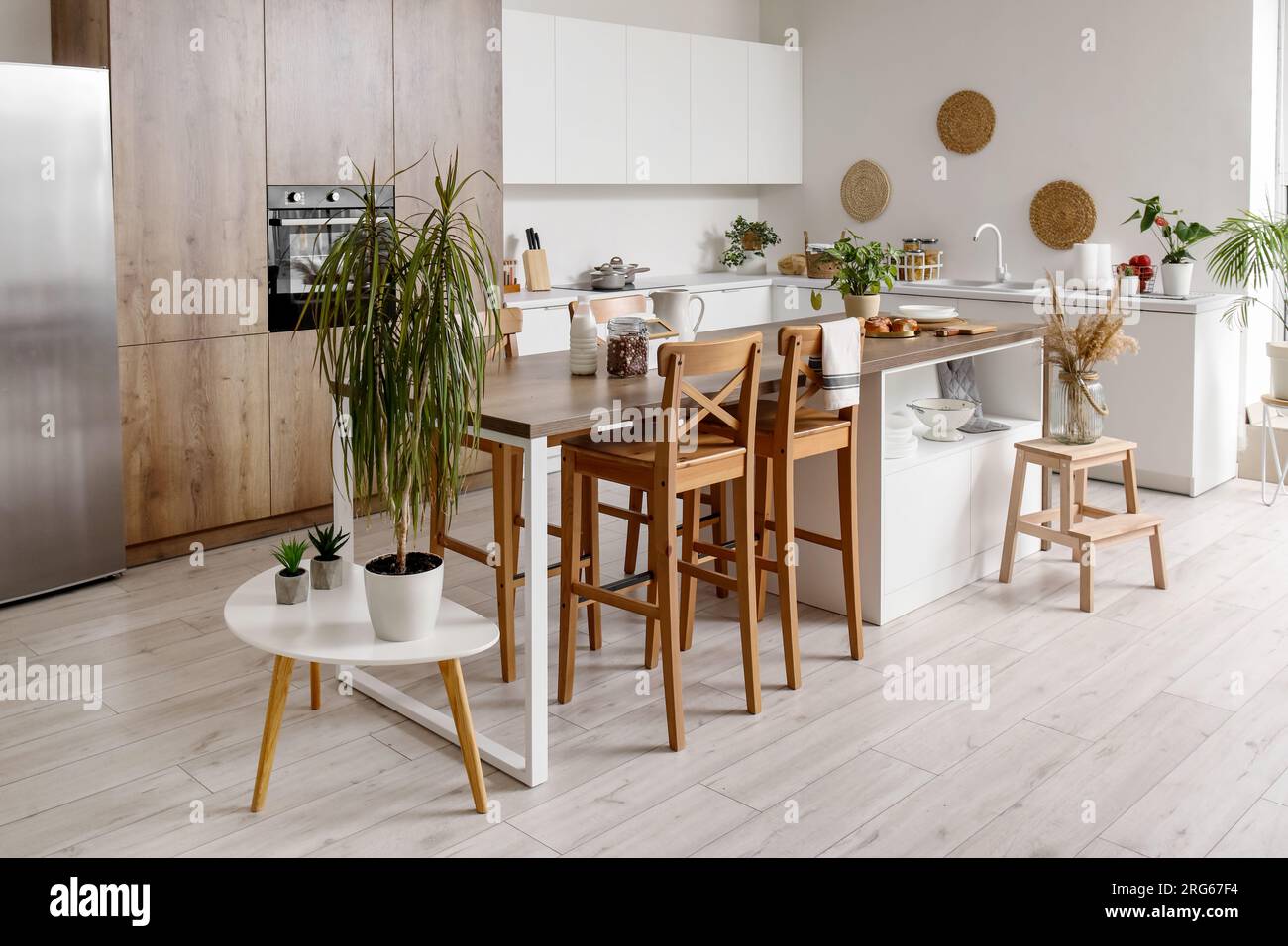 Interior of light kitchen with white counters, island and integrated ...