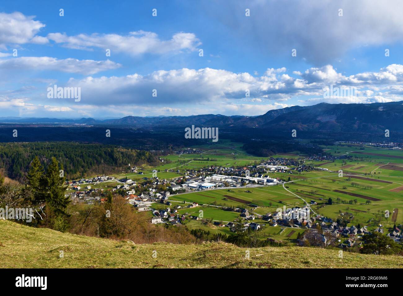 View of Begunje na Gorenjskem village in Slovenia surrounded by fields and forest Stock Photo