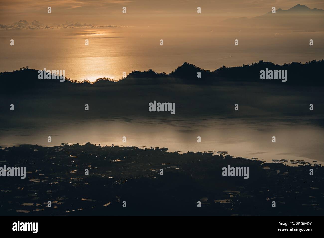 Early morning sunrise clouds at mountain Batur. Dawn mist covering ...