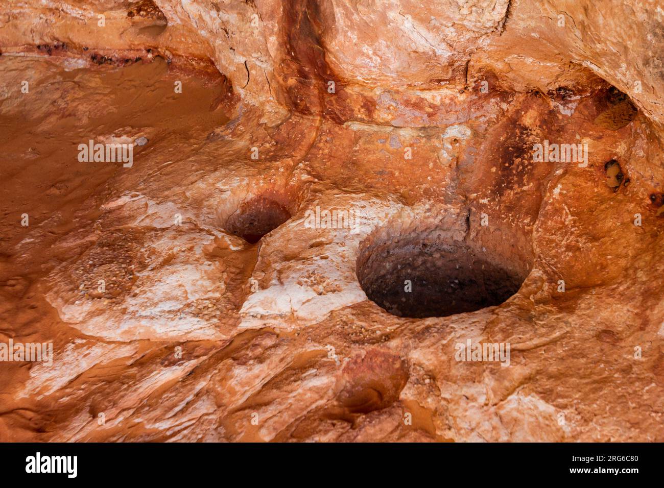 Prehistoric circular holes carved into the rock designed to collect water. Tadrart Rouge. Tassili N'Ajjer National Park. Algeria, Africa Stock Photo