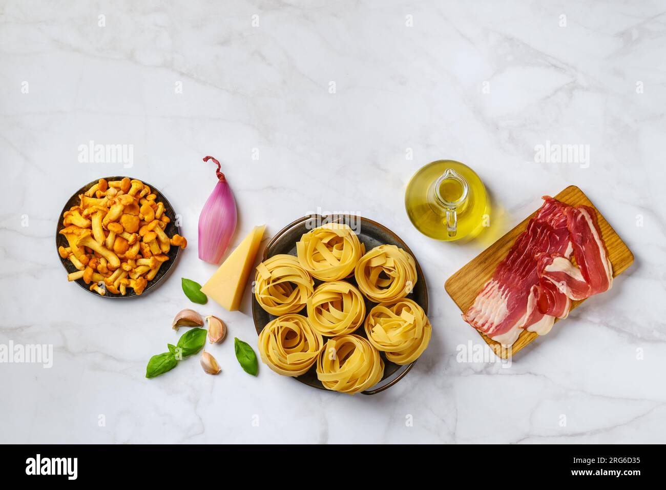 Raw fettuccine and ingredients for mushroom pasta with bacon Stock