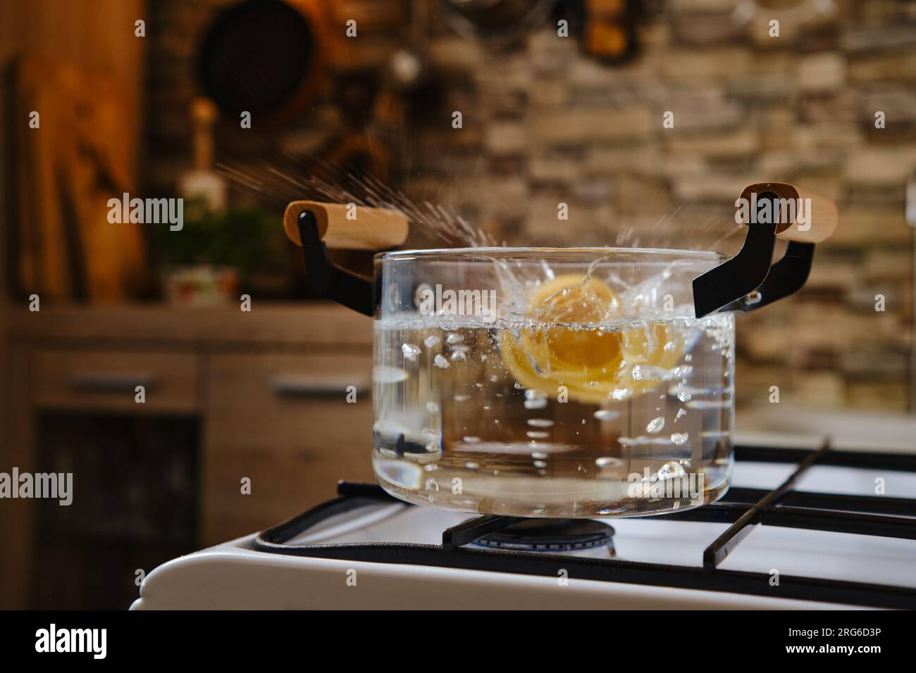Drop fettuccine pasta into boiling water in a saucepan Stock Photo Alamy