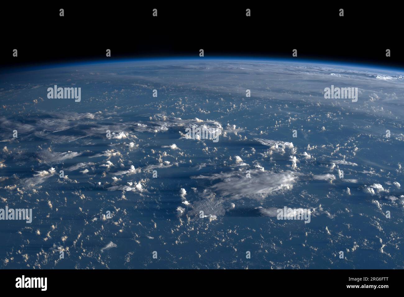 Sunrise casts long shadows from the clouds across the Philippine Sea