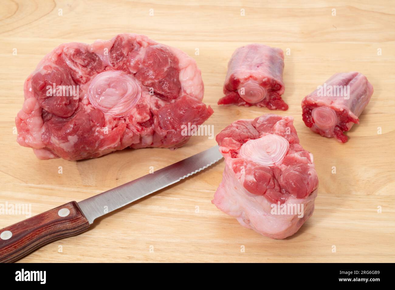 Fresh raw ox tail on a wooden cutting board Stock Photo