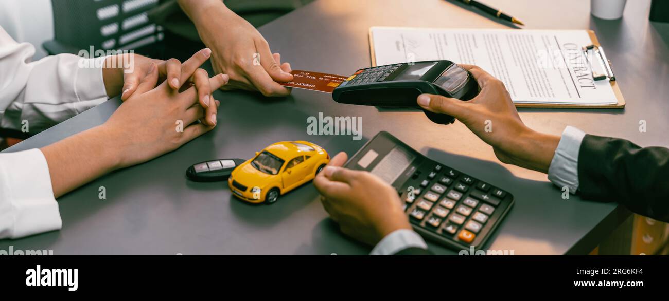 Customer client purchases new car with credit card via electronic