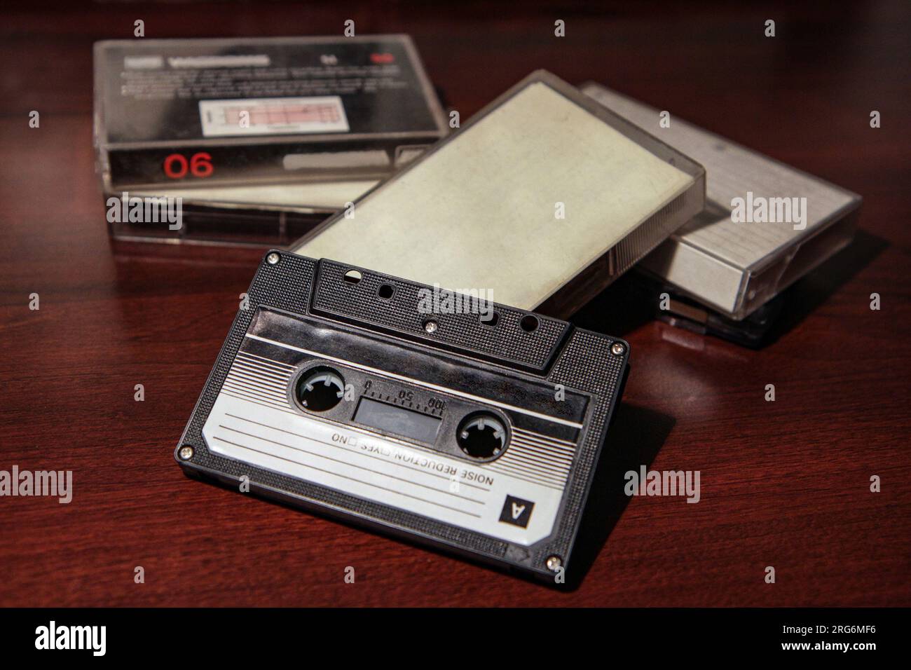 Blank cassette tape box on old wooden table background. Vintage cassette tape case with retro