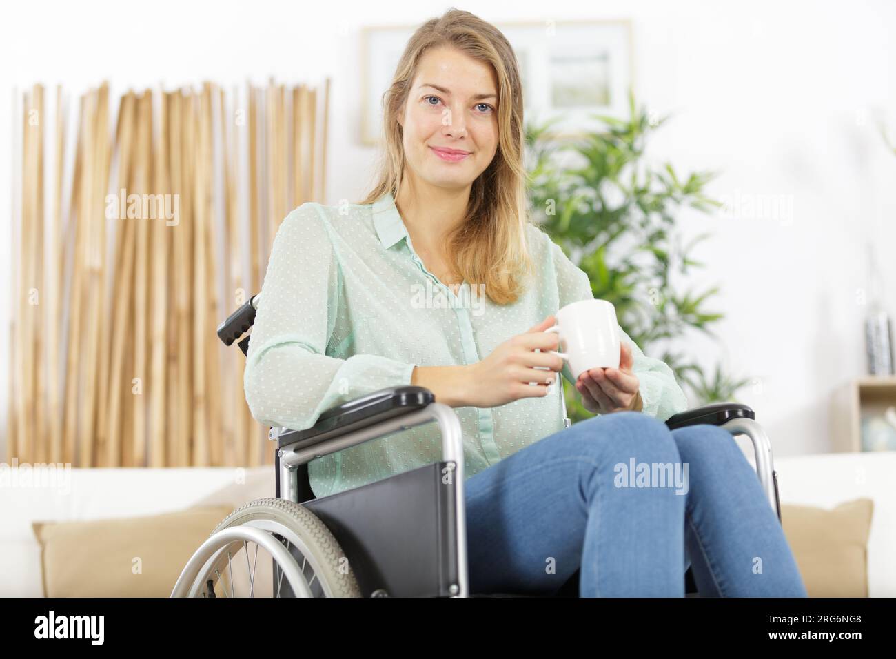 young woman in wheelchair indoors Stock Photo - Alamy