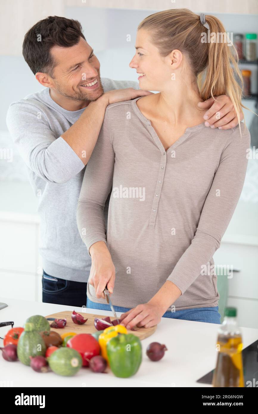 guy and smile girl cooking in domestic kitchen Stock Photo - Alamy