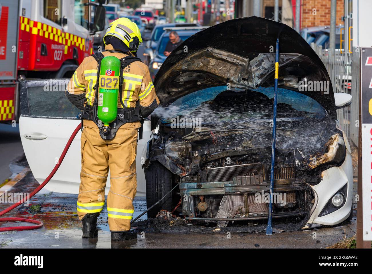 Aug 07, 2023: A member of Fire and Rescue NSW (FRNSW) attending a roadside car fire on Parramatta Road in western Sydney, New South Wales, Australia Stock Photo