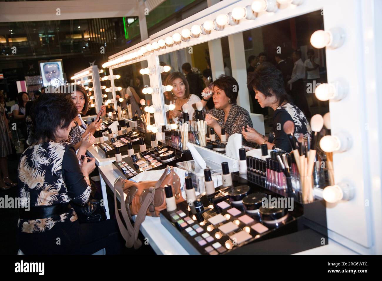 BANGKOK, THAILAND - May 11: cosmetic company AMWAY sponsores a makeup course with its products in the central world center and assists woman in using Stock Photo
