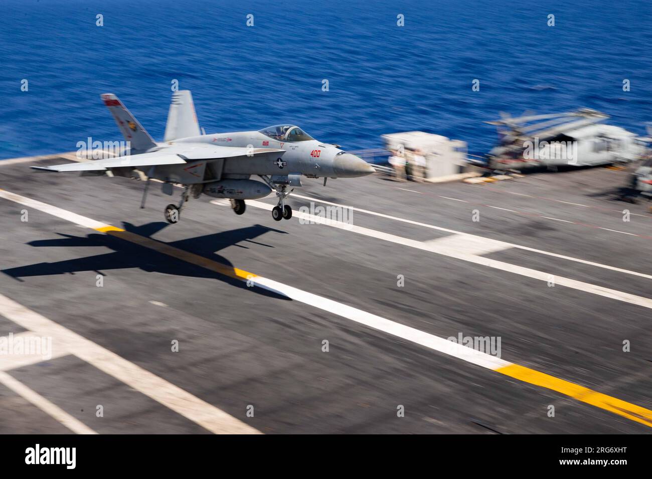 An F/A-18E Super Hornet, attached to the ÒGolden WarriorsÓ of Strike Fighter Squadron (VFA) 87, approaches the flight deck of the worldÕs largest aircraft carrier USS Gerald R. Ford (CVN 78), Aug. 6, 2023. Forces from Standing NATO Maritime Group 2 and the Gerald R. Ford Carrier Strike Group are conducting the Sage Wolverine series of high-end maritime training events in the central Mediterranean Sea to increase NATO interoperability and promote regional peace and stability. (U.S. Navy photo by Mass Communication Specialist Seaman Tajh Payne) Stock Photo