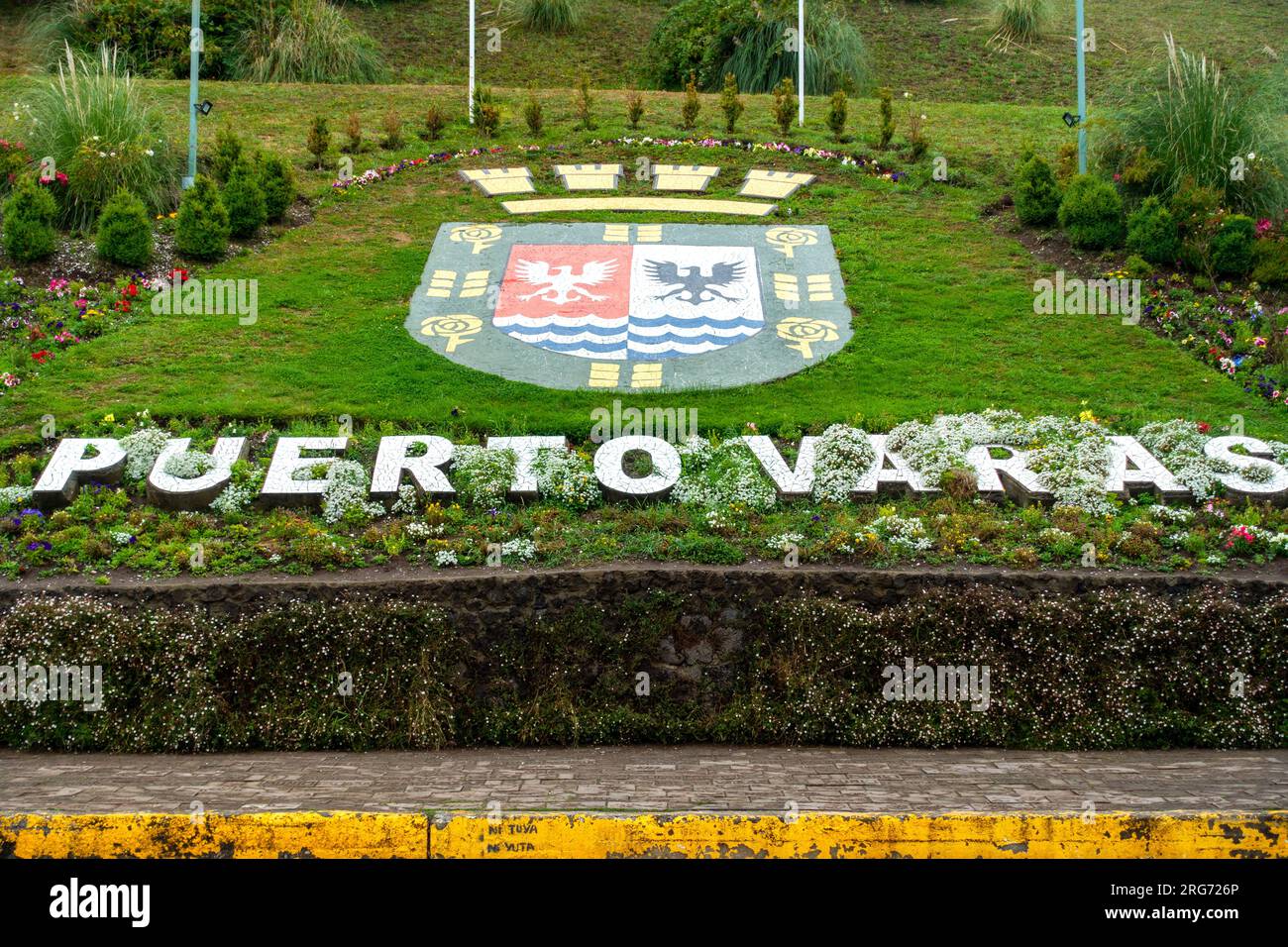 Puerto Varas, Chile City Entrance Text on Waterfront Avenue Park Green Grass with German Cultural Heritage Symbols Stock Photo