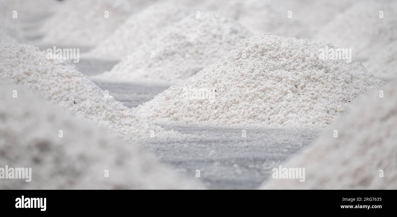 Sea salt farm. Pile of brine salt. Raw material of salt industrial. Sodium Chloride mineral. Evaporation and crystallization of sea water. White salt Stock Photo