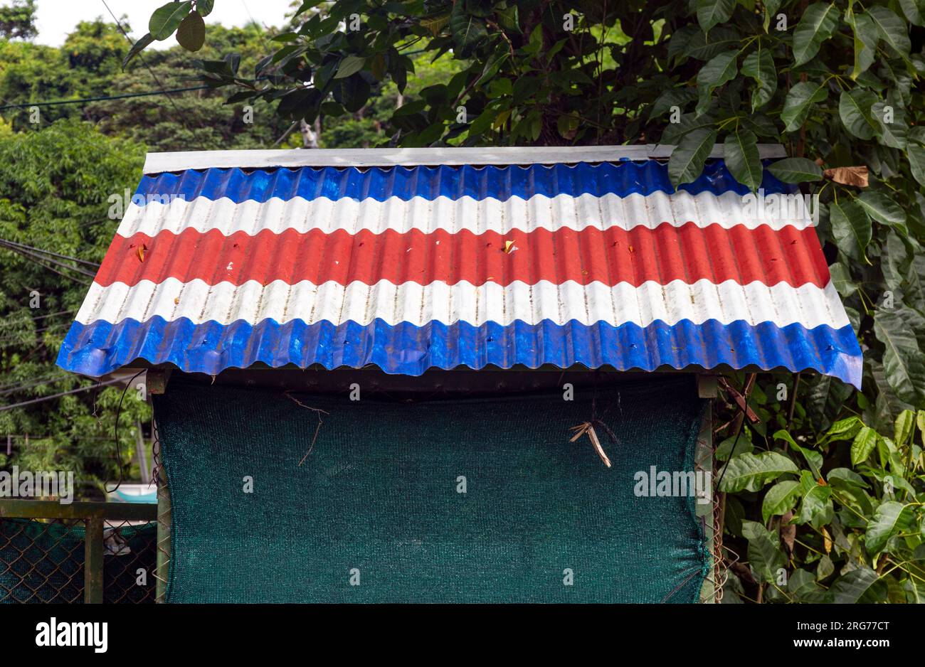 Costa Rican flag on shed roof Stock Photo