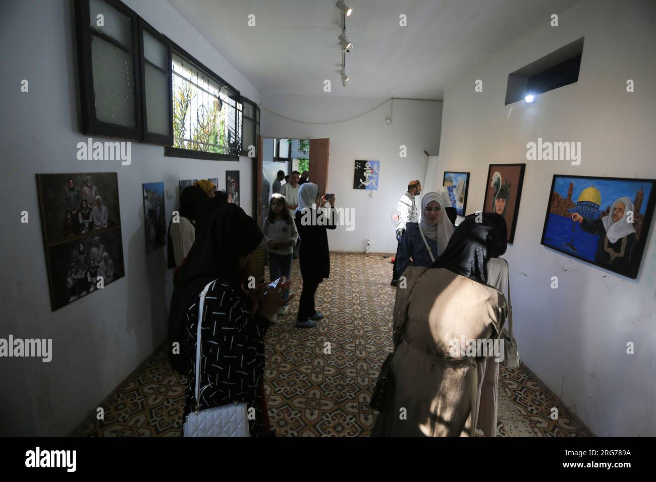 Gaza, Palestine. 25th June, 2023. Palestinians watch an art exhibition