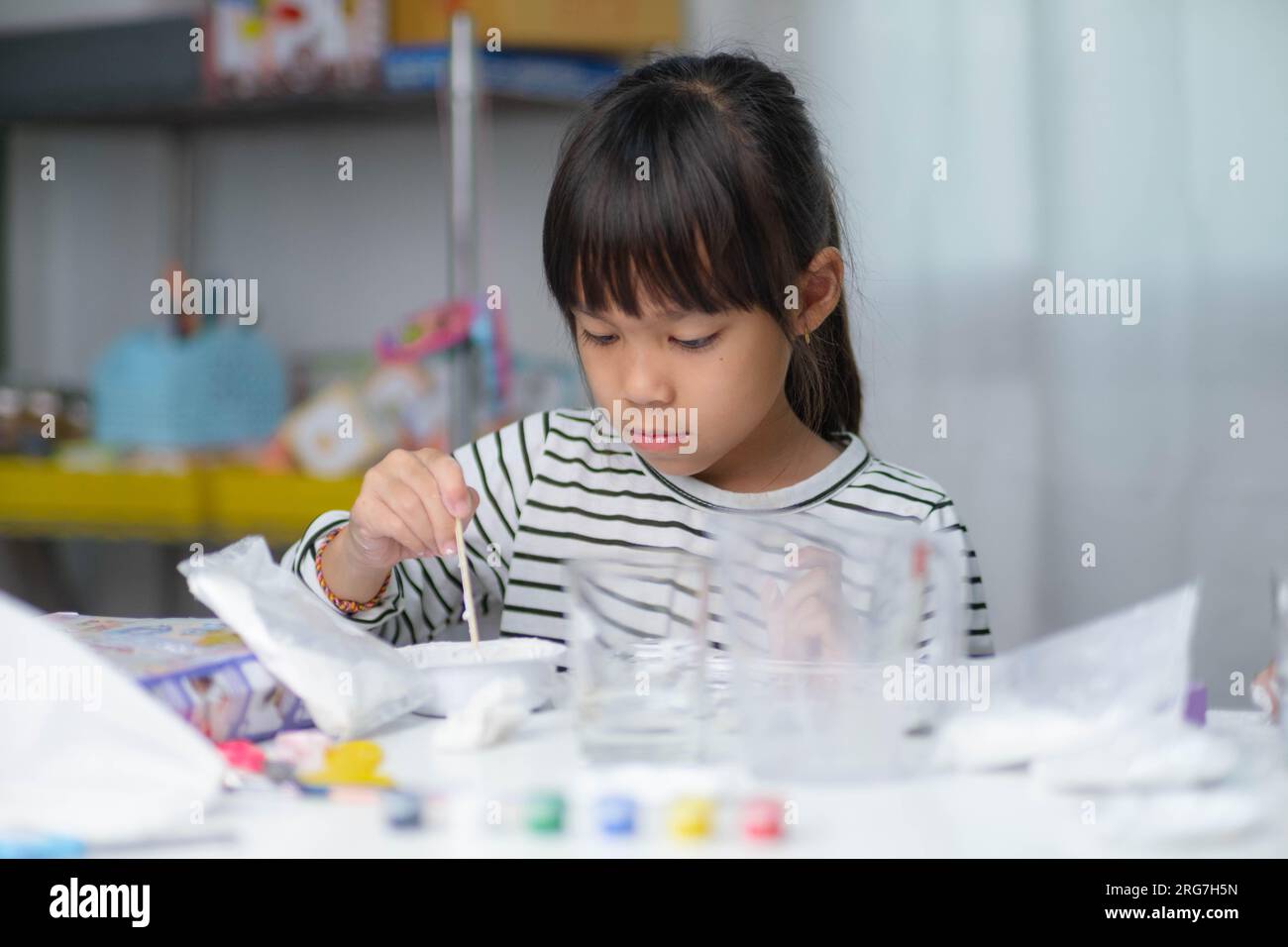 Cute little girl making DIY plaster and painting at home. Children ...