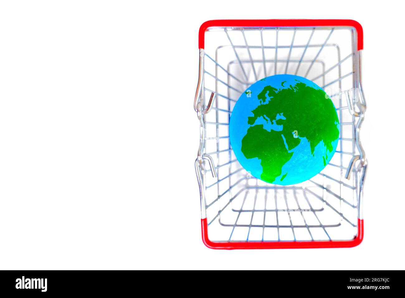 Shopping cart with a green and blue globe model isolated on white background with copy space