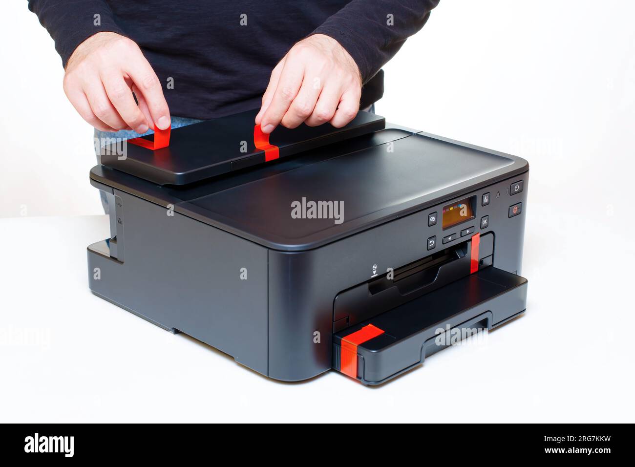 Employee carefully peels off orange transport stickers from a brand new