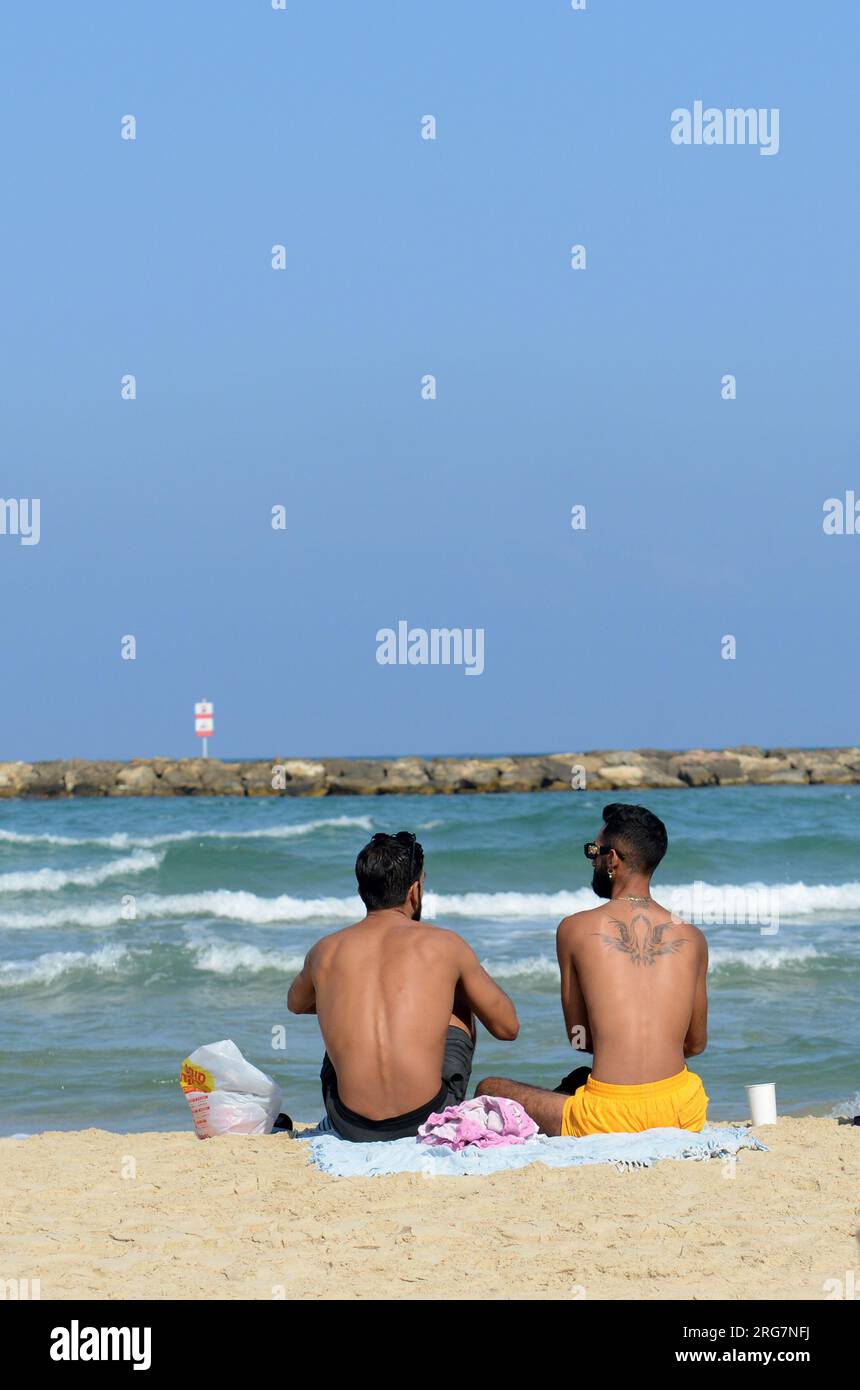 Guys chillin on the beach in Tel-Aviv, Israel. Stock Photo