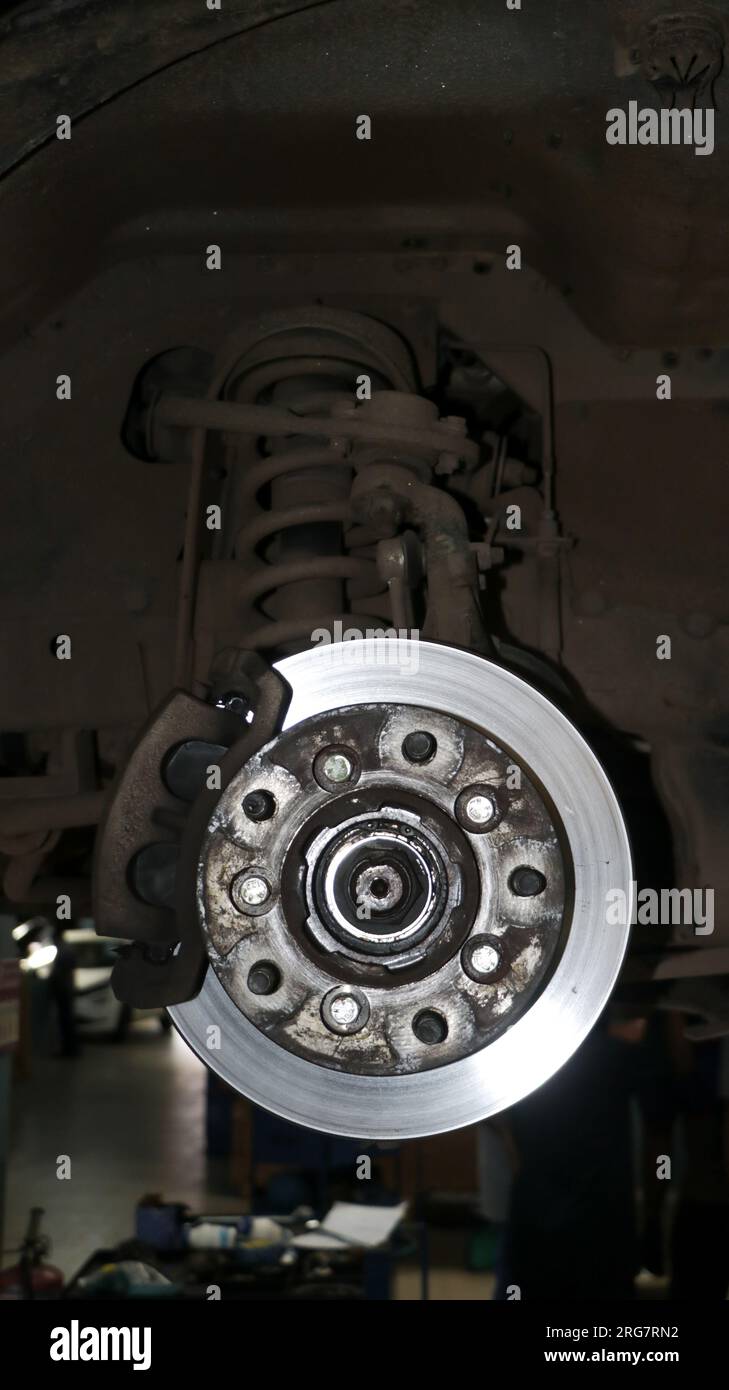 rusty old and dirty hydraulic parking disc brake and caliper of a car
