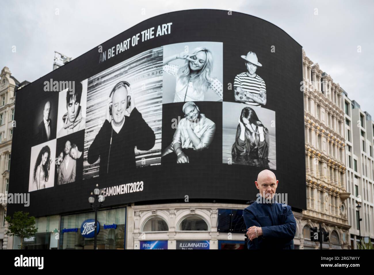 London, UK.  8 August 2023. Photographic artist Ray Burmiston at the launch of ‘Art of London Presents Take A Moment 2023’, his new photography exhibition featuring hundreds of famous faces with their eyes closed for mental health awareness.  Faces, including Fatboy Slim, are seen on the big screens at Piccadilly Circus, ahead of an exhibition in the National Portrait Gallery in September. Credit: Stephen Chung / Alamy Live News Stock Photo