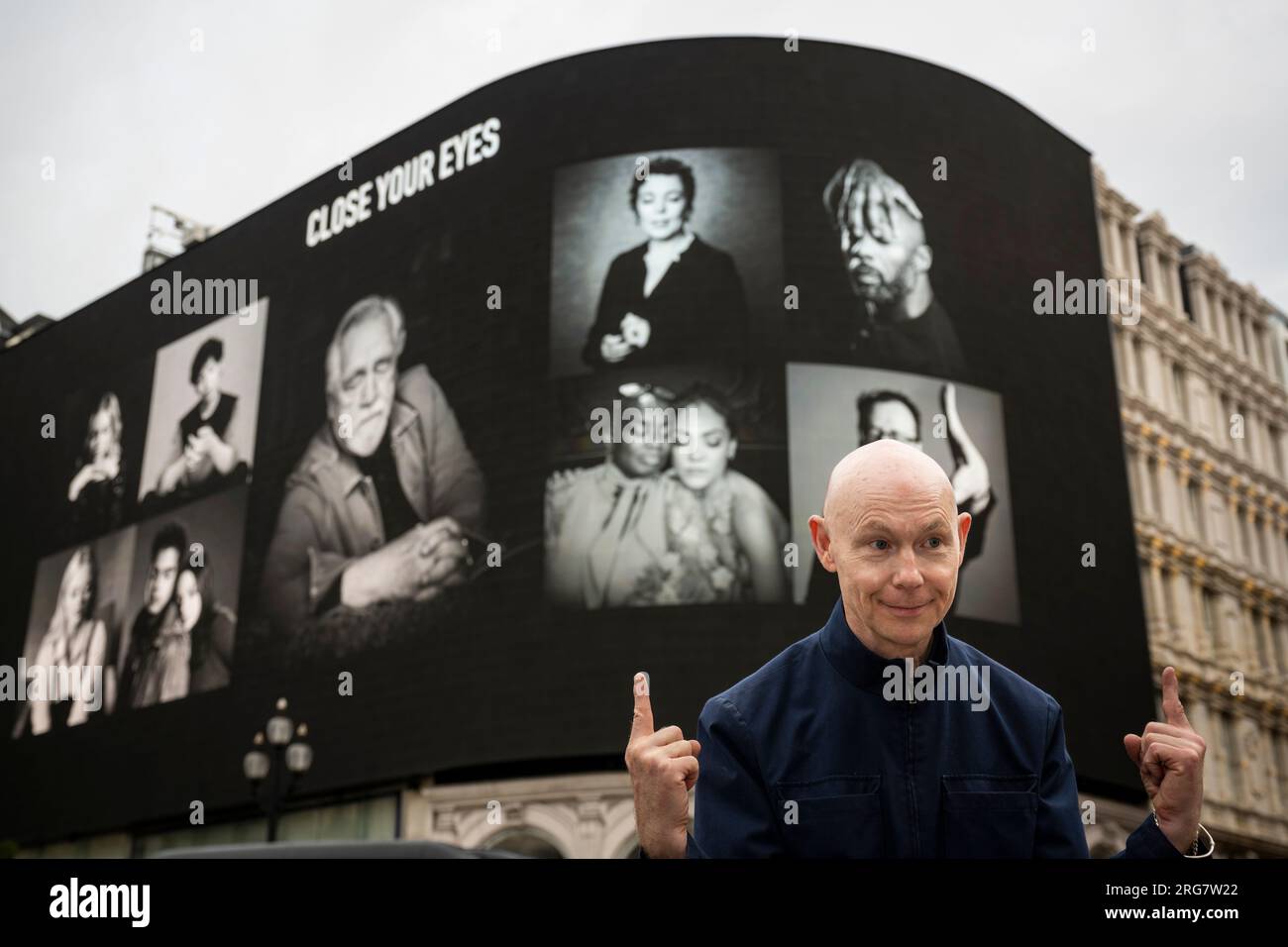 London, UK.  8 August 2023. Photographic artist Ray Burmiston at the launch of ‘Art of London Presents Take A Moment 2023’, his new photography exhibition featuring hundreds of famous faces with their eyes closed for mental health awareness.  Faces, including Brian Cox and Idris Elba, are seen on the big screens at Piccadilly Circus, ahead of an exhibition in the National Portrait Gallery in September.  Credit: Stephen Chung / Alamy Live News Stock Photo