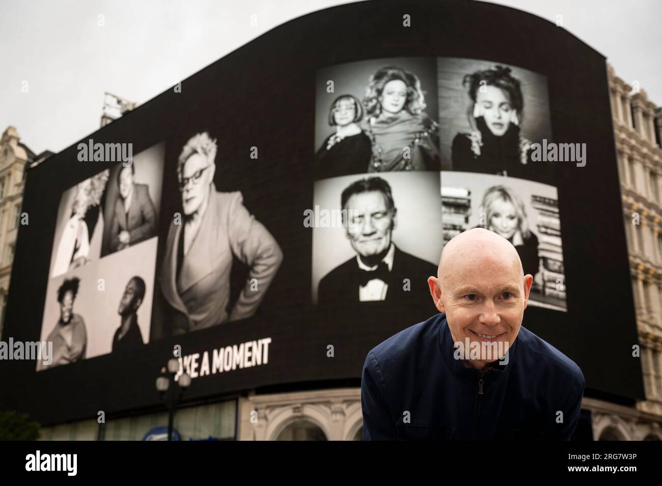 London, UK.  8 August 2023. Photographic artist Ray Burmiston at the launch of ‘Art of London Presents Take A Moment 2023’, his new photography exhibition featuring hundreds of famous faces with their eyes closed for mental health awareness.  Faces, including Eddie Izzard, Helena Bonham Carter and Michael Palin, are seen on the big screens at Piccadilly Circus, ahead of an exhibition in the National Portrait Gallery in September.  Credit: Stephen Chung / Alamy Live News Stock Photo