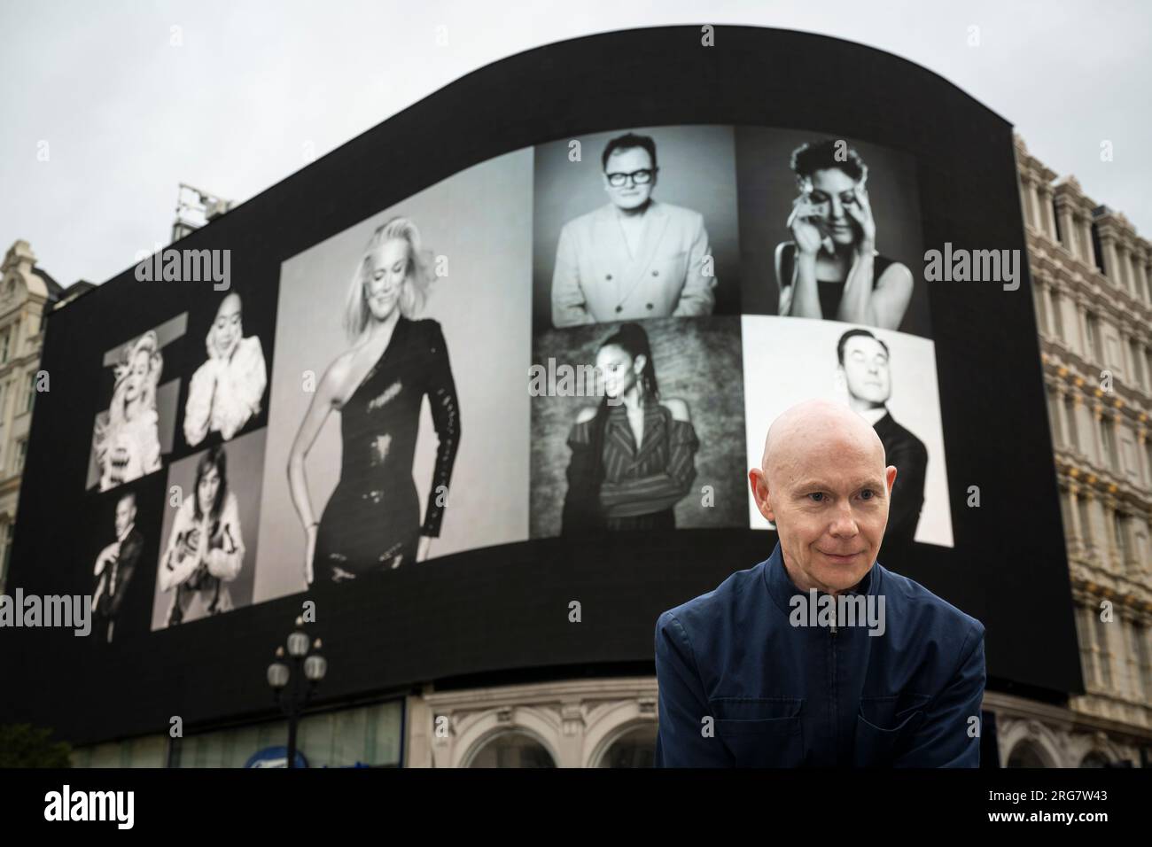 London, UK.  8 August 2023. Photographic artist Ray Burmiston at the launch of ‘Art of London Presents Take A Moment 2023’, his new photography exhibition featuring hundreds of famous faces with their eyes closed for mental health awareness.  Faces, including Alam Carr and David Walliams, are seen on the big screens at Piccadilly Circus, ahead of an exhibition in the National Portrait Gallery in September.  Credit: Stephen Chung / Alamy Live News Stock Photo