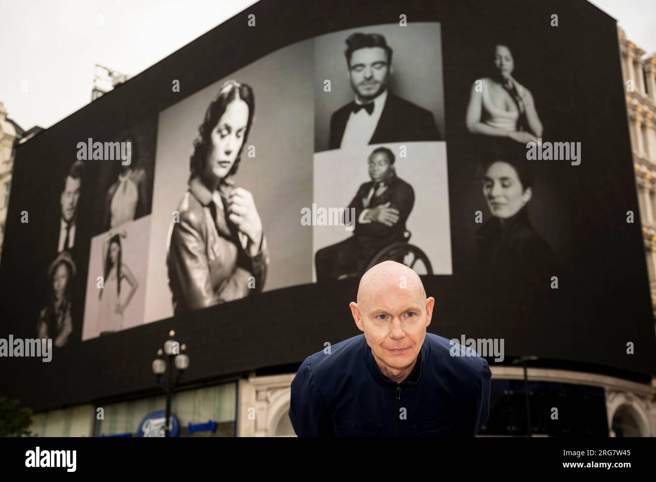 London, UK.  8 August 2023. Photographic artist Ray Burmiston at the launch of ‘Art of London Presents Take A Moment 2023’, his new photography exhibition featuring hundreds of famous faces with their eyes closed for mental health awareness.  Faces, including Ruth Wilson and Richard Madden, are seen on the big screens at Piccadilly Circus, ahead of an exhibition in the National Portrait Gallery in September.  Credit: Stephen Chung / Alamy Live News Stock Photo